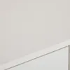 A close-up view of a white cabinet or dresser with a drawer or door visible. Produktbild-Vorschau