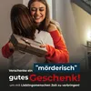 Two women hugging, one is giving a gift to the other. Produktbild-Vorschau