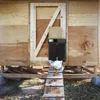 A chicken coop with an automatic door opener and a chicken on the ramp. Produktbild-Vorschau