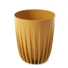 A mustard-colored planter pot with a ribbed texture, shown against a white background. Náhled obrázku produktu