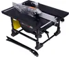 A black table saw with a clear blade guard and a yellow insert, shown on a white background. A black push stick is in the foreground. Anteprima dell’immagine prodotto