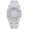 A diamond-encrusted luxury watch with Arabic numerals on a white background. Produktbild-Vorschau