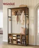 An entryway furniture piece with coat hooks and shoe storage, styled with accessories like a hat, scarf, and pillow. Produktbild-Vorschau