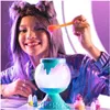 A young girl is making slime with a potion maker kit. Náhled obrázku produktu