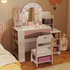 A child's vanity set with a mirror, chair, and storage shelves, set in a bedroom. Náhled obrázku produktu