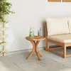 A small wooden table with drinks on a patio next to a sofa. Náhled obrázku produktu