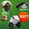 A man carrying a large bag over his shoulder, next to a two-wheeled wheelbarrow and stacks of bags. Produktbild-Vorschau