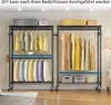 Two garment racks with clothes and storage bins are shown in a room. Voir les images du produit