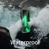 A waterproof phone case is submerged in crashing waves on rocks. Produktbild-Vorschau