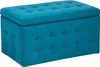 A tufted ottoman with storage in a marine blue velvet fabric, shown from a three-quarter angle against a white background. Podgląd zdjęcia produktu