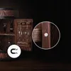 A wooden barrel-shaped bar cabinet with glasses and bottles displayed inside, with a close-up inset showing a magnetic closure. Produktbild-Vorschau