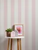 A small round table with decorative items against a striped wallpaper. Produktbild-Vorschau