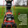 A person is using a lawnmower in a grassy field. Produktbild-Vorschau