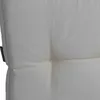 A close-up view of a tufted cream-colored cushion or mattress. Produktbild-Vorschau