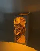 A wooden miniature model of Diagon Alley, lit from within, sits on a white surface against a gray wall. Produktbild-Vorschau