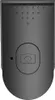 A black selfie stick remote with a camera icon button. Voir les images du produit