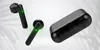 Three black wireless earbuds and their charging case are displayed against a light gray background with subtle leaf-like shadows. Produktbild-Vorschau