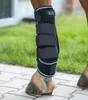 A close-up of a horse's leg wearing a black and blue therapeutic boot. Podgląd zdjęcia produktu