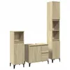 Three pieces of light brown wooden bathroom furniture, including a tall cabinet and a vanity unit with drawers, are arranged against a white background. Anteprima dell’immagine prodotto
