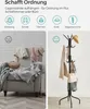 A split image showing a messy chair with clothes and a tidy coat rack with clothes and a hat. Náhled obrázku produktu