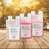 Three bottles of liquid supplements for chickens are displayed on a wooden surface with a blurred background of trees and sunlight. Produktbild-Vorschau