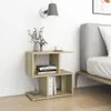 A bedside table with books and a vase of flowers next to a bed. Produktbild-Vorschau