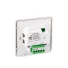 The back of a white digital thermostat with green terminal blocks. Produktbild-Vorschau