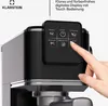 A close-up of a coffee machine's control panel with a hand touching a button. Produktbild-Vorschau