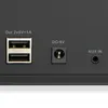 A close-up view of the back panel of a black electronic device, showing various ports and labels. Produktbild-Vorschau