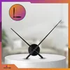 A modern wall clock with a 3D mirror effect, displayed on a white pedestal against a blurred background. Náhled obrázku produktu