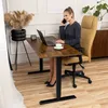 A woman is working at a desk in an office setting. Náhled obrázku produktu