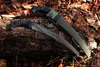Two saws are laid on a log with fallen leaves around them. Produktbild-Vorschau