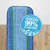 A close-up of a microfiber mop pad on a tiled and wooden floor background, with a circular graphic highlighting its cleaning capabilities. Produktbild-Vorschau