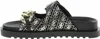 A side view of a black Guess sandal with a gold chain detail and a repeating Guess logo pattern. Podgląd zdjęcia produktu