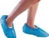 A person's legs and feet wearing blue disposable shoe covers. Náhľad obrázku produktu
