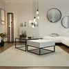 A modern living room with a white sectional sofa, coffee tables, and decorative elements. Voir les images du produit