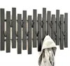 A black metal wall-mounted coat rack with multiple hooks against a white background. A grey jacket is hanging on one of the hooks. Produktbild-Vorschau
