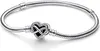 A silver bracelet with a heart-shaped charm featuring an infinity symbol and small stones, displayed on a white background. Náhľad obrázku produktu