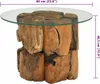A round glass-top coffee table with a base made of stacked pieces of teak driftwood. Náhľad obrázku produktu
