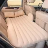 An inflatable car mattress is set up in the back seat of a car, with pillows placed on it. Produktbild-Vorschau