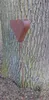 A rusty metal heart garden stake is placed next to a tree trunk. Produktbild-Vorschau