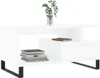 A white coffee table with black legs, featuring a decorative plant in a vase and a stack of books on the shelf. A second book is placed on top of a drawer unit. Voir les images du produit