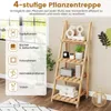 A wooden plant stand with decorative items on display, next to a window with natural light. Náhled obrázku produktu