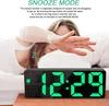 A person is sleeping in bed, reaching out to turn off an alarm clock. Produktbild-Vorschau