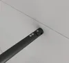 A close-up view of a black metal bar with screws, attached to a light gray surface. Produktbild-Vorschau