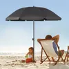 A father and daughter are enjoying a day at the beach under a large black umbrella. Produktbild-Vorschau