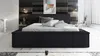 A modern bedroom with a black upholstered bed. Produktbild-Vorschau