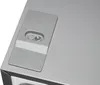 Close-up of a gray panel with a screw and a button on it, likely part of an appliance. Produktbild-Vorschau