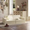 A children's playroom with a cream-colored modular sofa, a dresser, and wall art. Náhled obrázku produktu