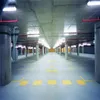 An empty parking garage with concrete pillars and yellow markings on the floor. Produktbild-Vorschau